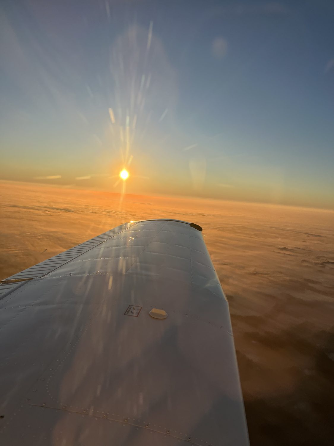 Sunburst over the wing at altitude