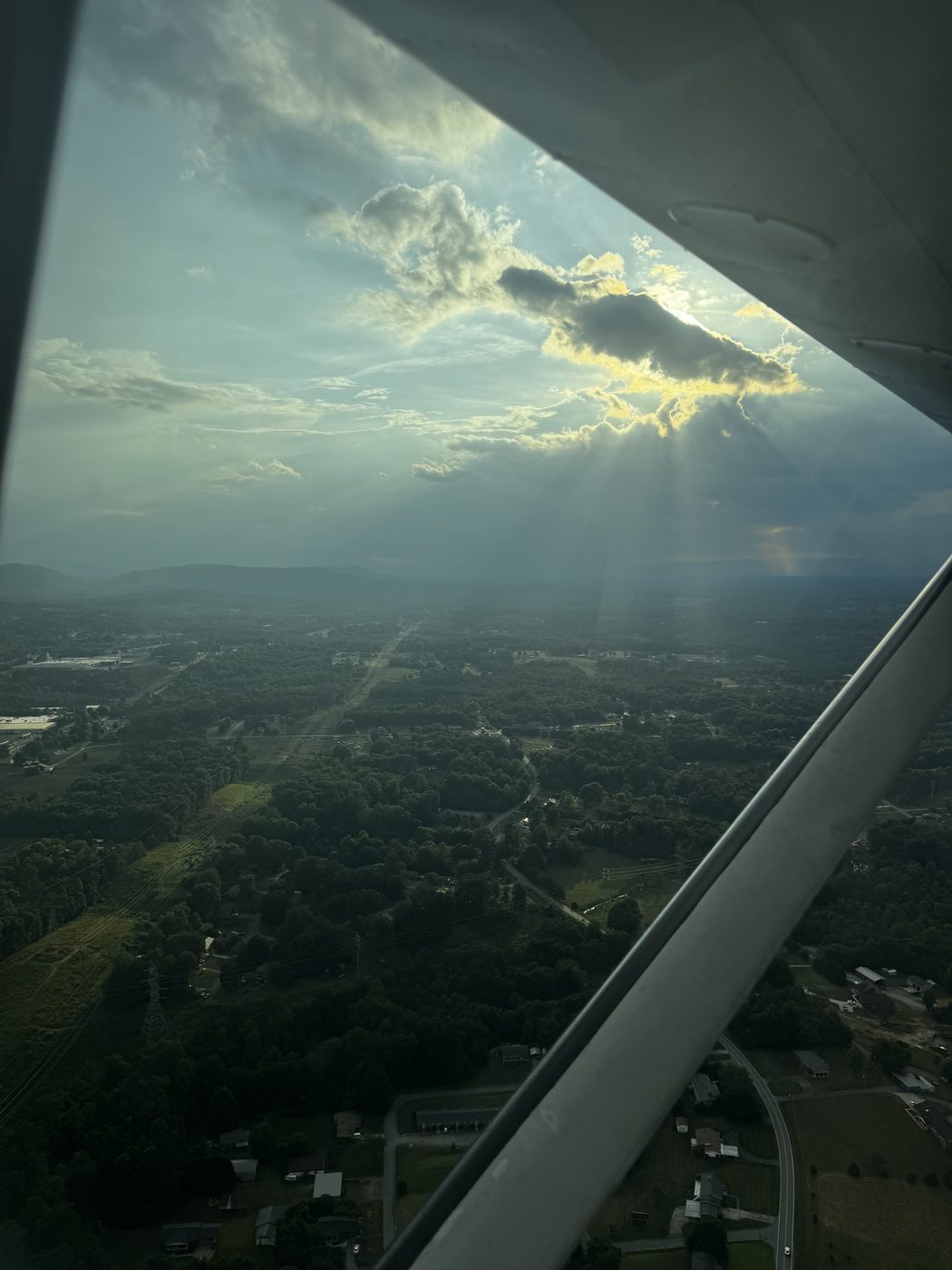 Sunbeams breaking through clouds over the foothills